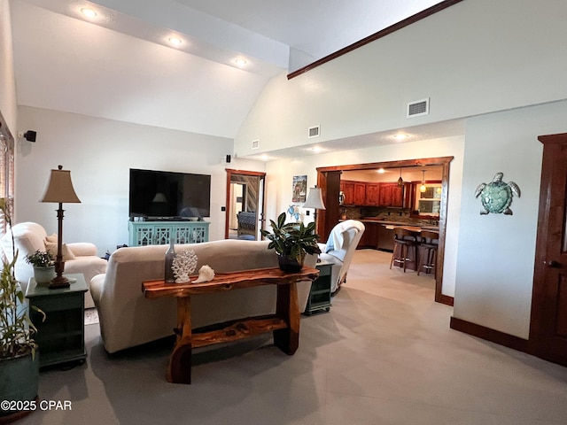living room with visible vents, high vaulted ceiling, and light colored carpet