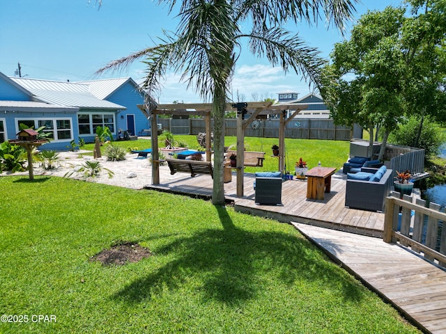 view of yard with an outdoor living space, a wooden deck, and fence