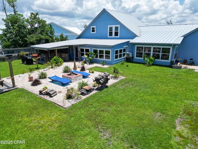 back of property with an outdoor fire pit, a yard, a patio, and metal roof