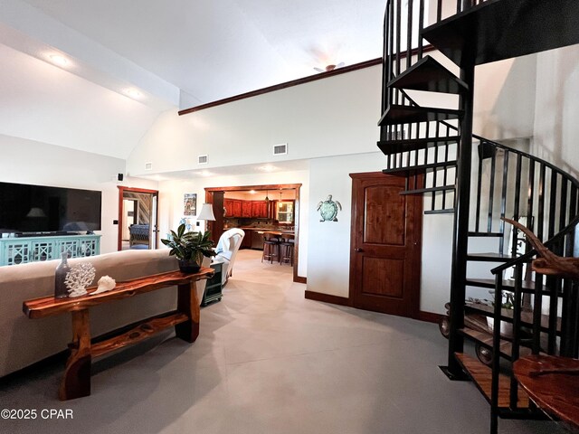 living room with stairway, visible vents, high vaulted ceiling, and baseboards