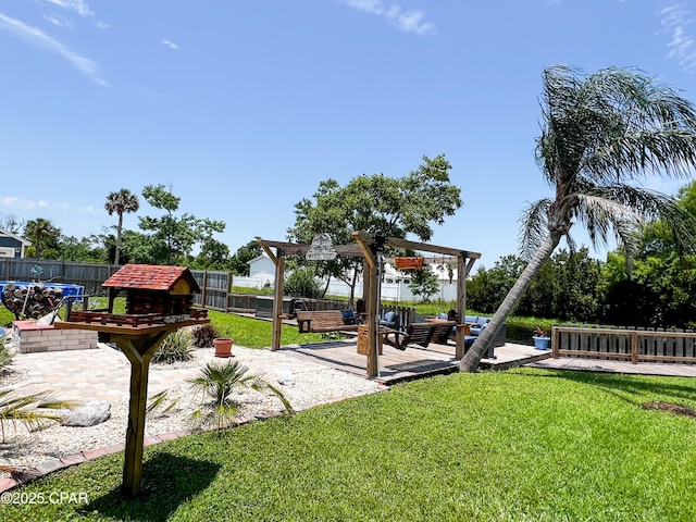 view of playground with a lawn, an outdoor living space, a patio, and a fenced backyard