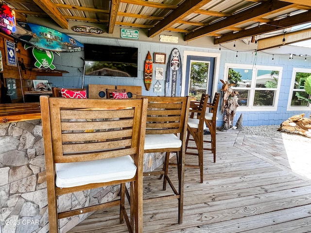 dining area featuring hardwood / wood-style floors and beam ceiling