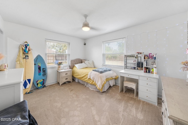 carpeted bedroom with ceiling fan and multiple windows