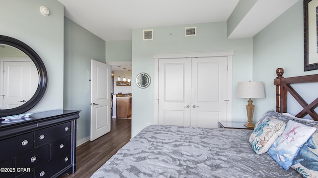 bedroom featuring dark wood-type flooring and a closet