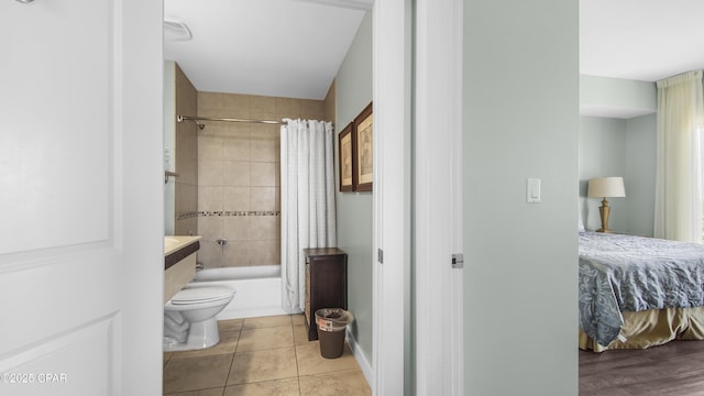 full bathroom with tile patterned floors, toilet, vanity, and shower / tub combo