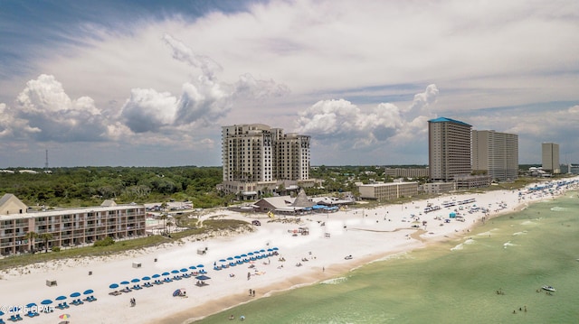 birds eye view of property with a water view and a beach view