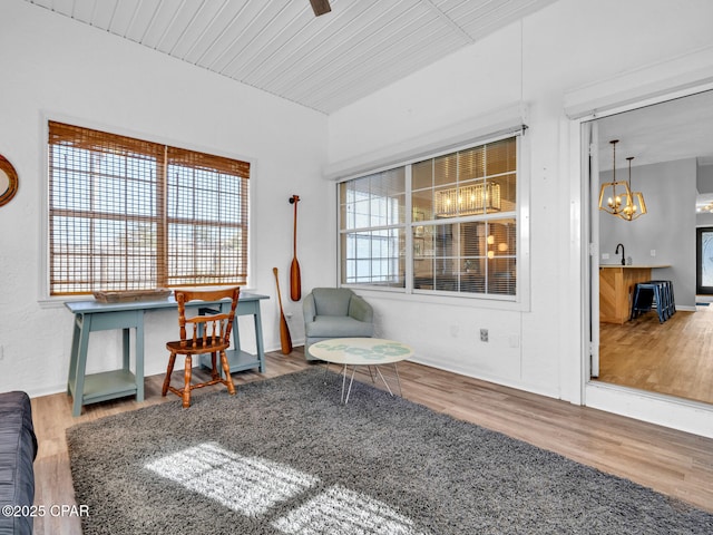 sitting room with wood finished floors and wood ceiling