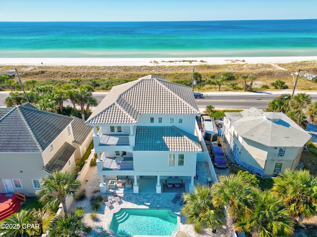 birds eye view of property featuring a beach view and a water view