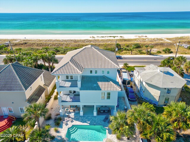 birds eye view of property with a water view and a view of the beach