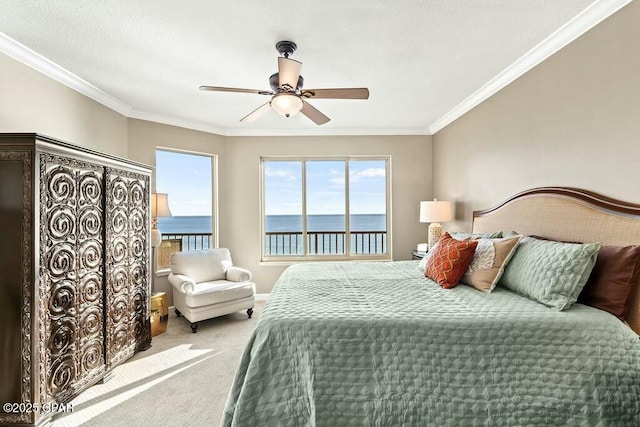 carpeted bedroom with ornamental molding, access to exterior, a water view, and ceiling fan