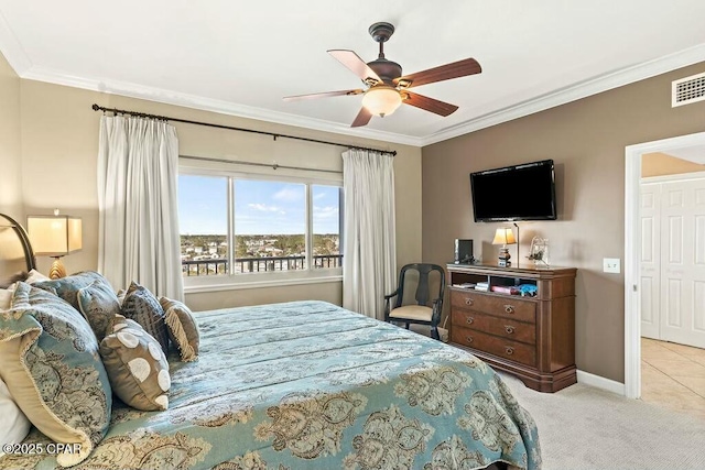 carpeted bedroom featuring baseboards, visible vents, ornamental molding, and ceiling fan