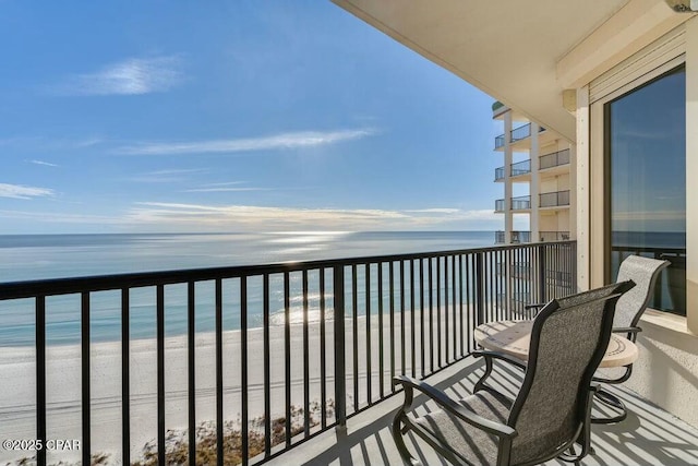 balcony with a beach view and a water view