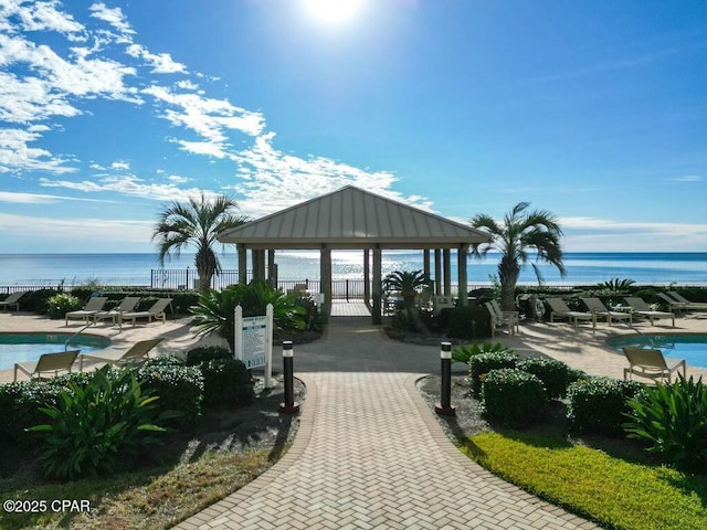 view of community featuring a water view, a patio, a gazebo, and a swimming pool