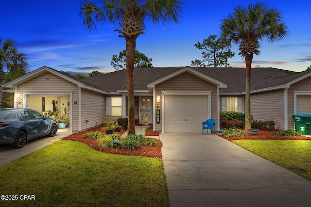 single story home with a garage and a lawn