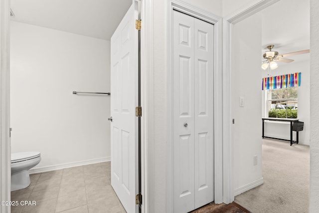 bathroom with ceiling fan, tile patterned floors, and toilet