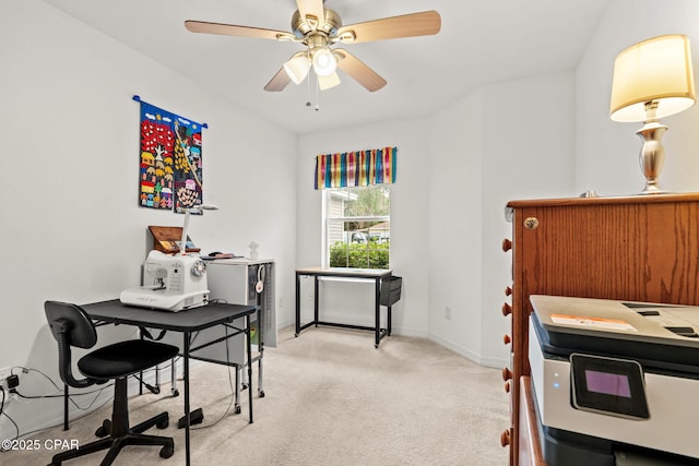 carpeted office featuring ceiling fan
