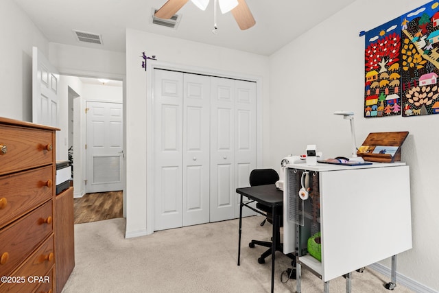 office with light carpet and ceiling fan