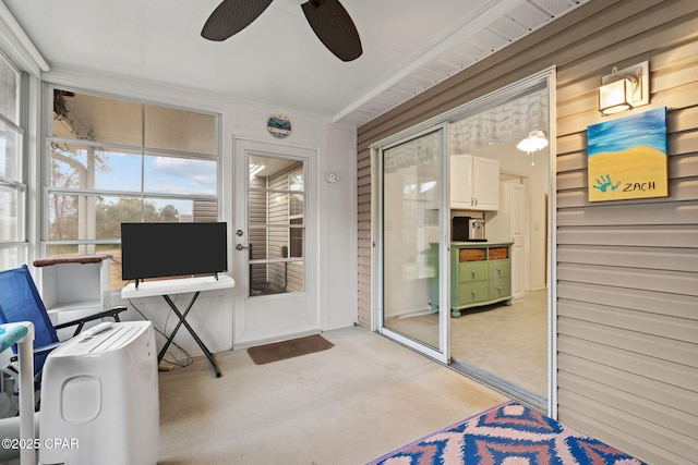 sunroom featuring ceiling fan
