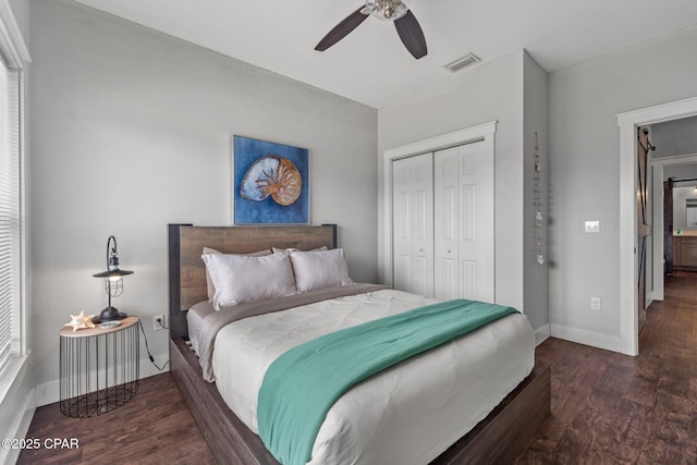 bedroom featuring ceiling fan, a closet, and dark hardwood / wood-style floors