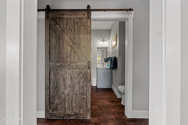 bathroom featuring toilet, hardwood / wood-style floors, and vanity