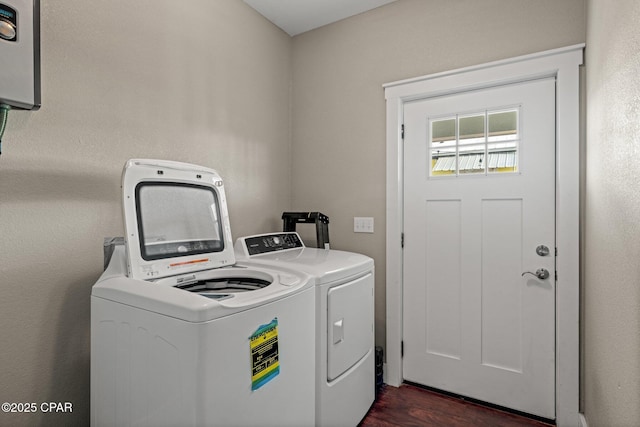 clothes washing area with dark hardwood / wood-style floors and washing machine and clothes dryer