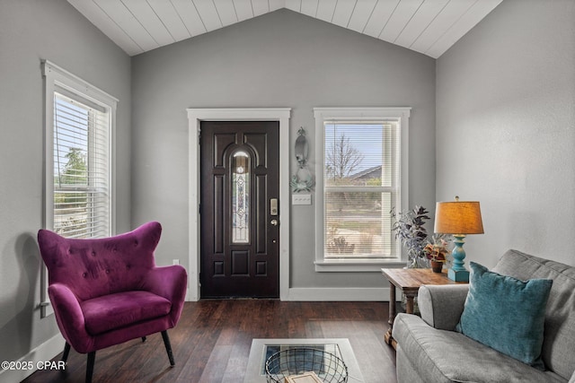 living area with dark wood-type flooring, plenty of natural light, and lofted ceiling