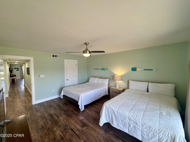 unfurnished bedroom featuring dark wood-type flooring and ceiling fan