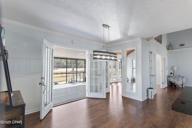 dining room with french doors, dark wood-type flooring, crown molding, and a textured ceiling