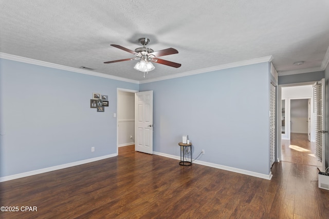 spare room featuring ceiling fan, dark hardwood / wood-style floors, crown molding, and a textured ceiling