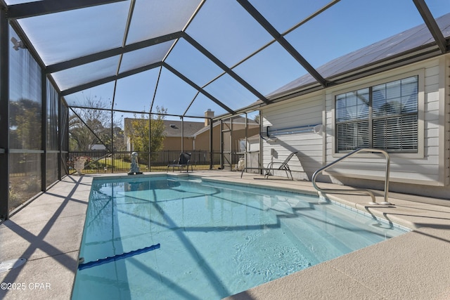 view of swimming pool with a lanai and a patio