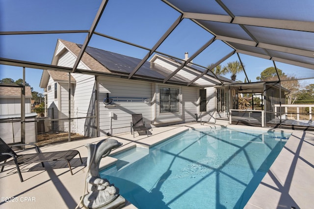 view of pool featuring a patio area, a lanai, and a hot tub