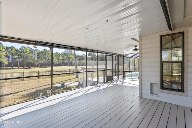 wooden deck featuring a fenced in pool and glass enclosure