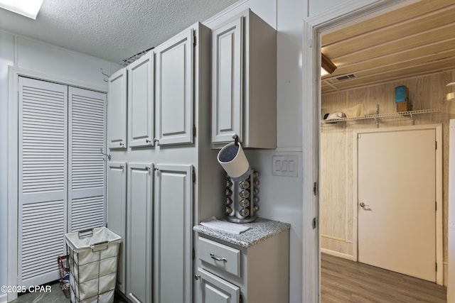 kitchen with dark hardwood / wood-style floors and a textured ceiling