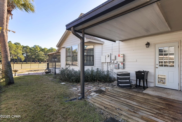 deck with central AC unit and a yard