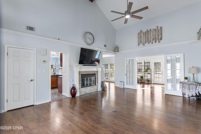 living room with high vaulted ceiling, dark wood-type flooring, ceiling fan, and french doors