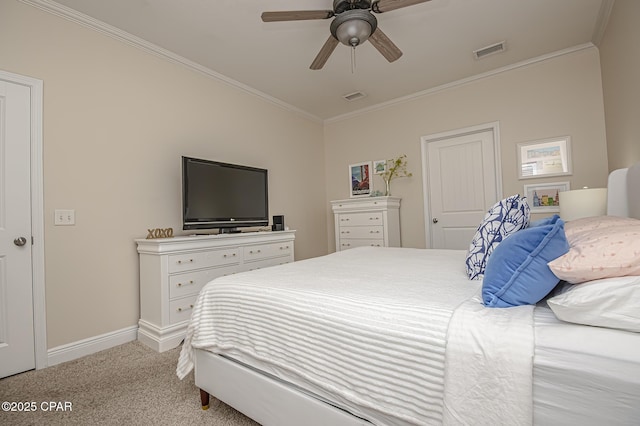 carpeted bedroom with ceiling fan and ornamental molding