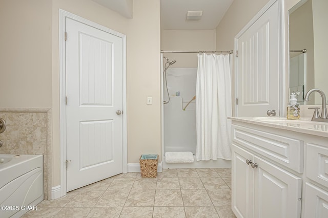 bathroom with washer / clothes dryer, shower with separate bathtub, vanity, and tile patterned flooring