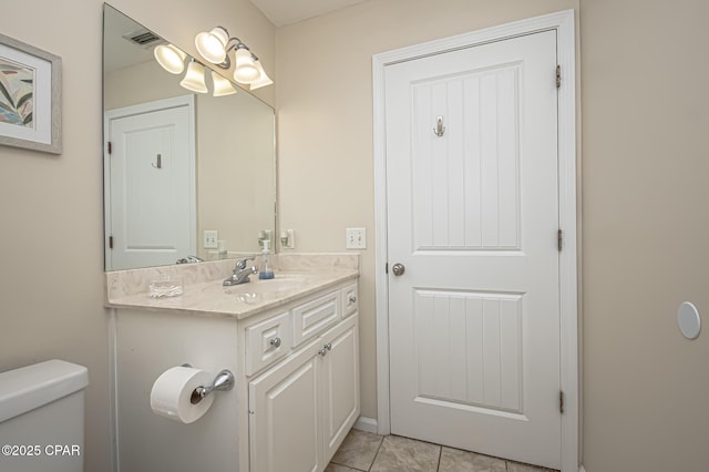 bathroom featuring toilet, vanity, and tile patterned floors