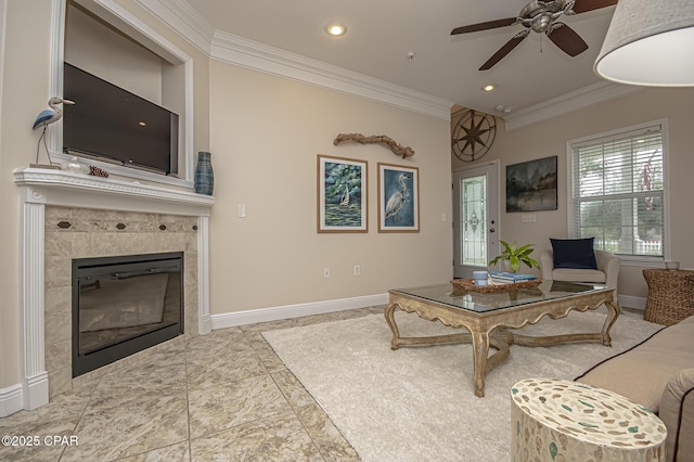 living room featuring ceiling fan, a fireplace, and crown molding