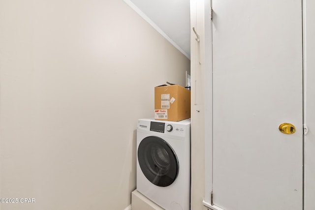 washroom featuring crown molding and washer / dryer