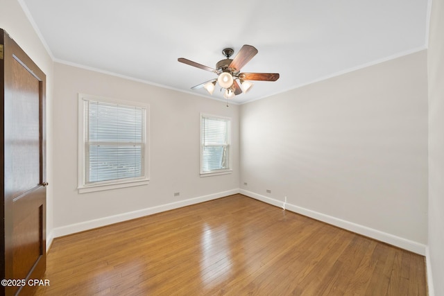 spare room with crown molding, light hardwood / wood-style floors, and ceiling fan