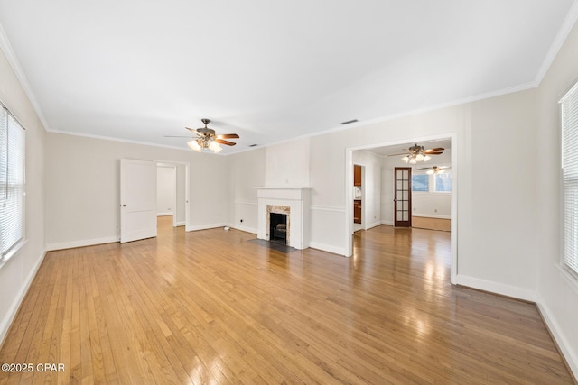 unfurnished living room with hardwood / wood-style flooring, ceiling fan, and crown molding