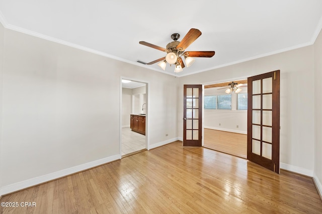 unfurnished room featuring ceiling fan, ornamental molding, french doors, and light wood-type flooring