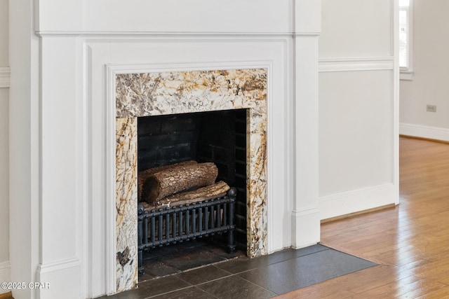 details featuring hardwood / wood-style flooring and a high end fireplace