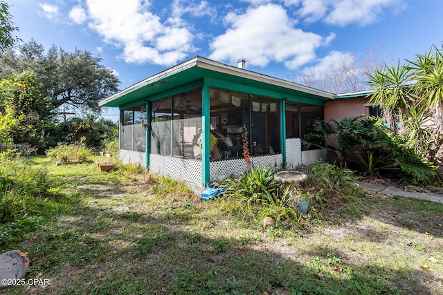 view of home's exterior with a sunroom