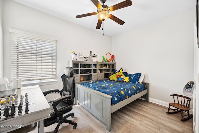 bedroom with ceiling fan and light hardwood / wood-style flooring