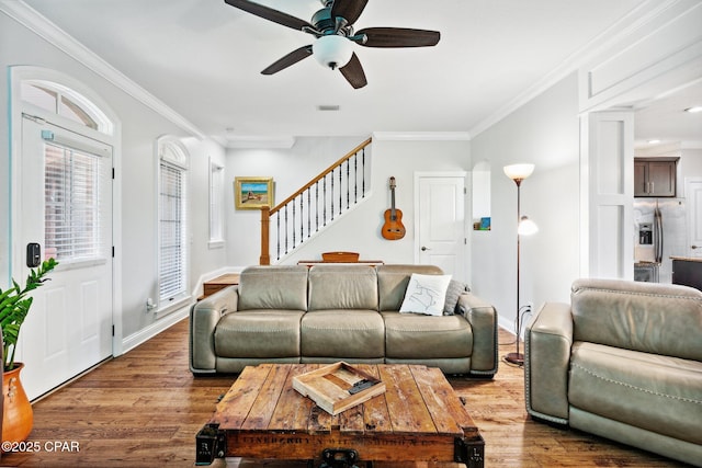 living room featuring crown molding, ceiling fan, and light wood-type flooring