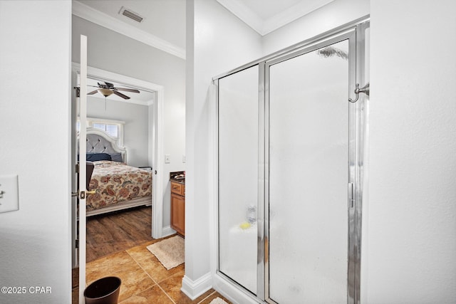 bathroom with walk in shower, ornamental molding, vanity, ceiling fan, and tile patterned flooring