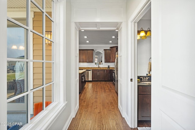 hallway with dark hardwood / wood-style flooring and crown molding