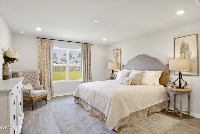 bedroom featuring light wood finished floors, baseboards, and recessed lighting